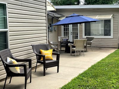 Outdoor seating area with patio umbrella and furniture