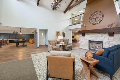 Bright common area with comfortable seating and pool table