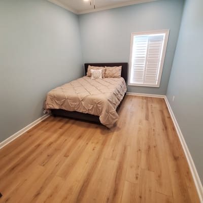 Neatly arranged private resident room with light blue walls