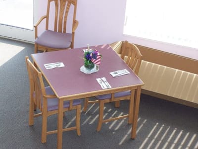 Well-set dining table in a brightly lit room