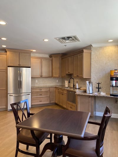 Bright kitchen space with wooden cabinets and table