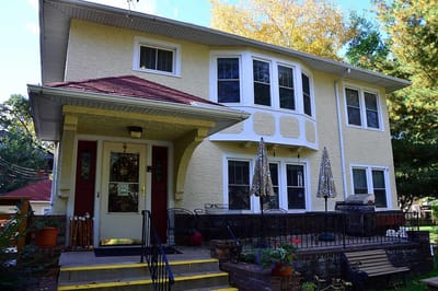Exterior view of a yellow house with a porch