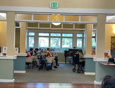 Residents enjoying a musical performance in a social area