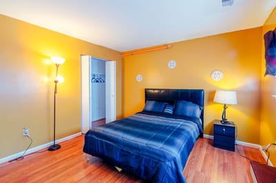 Cozy bedroom with a bed, lamp, and nightstand