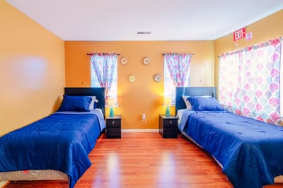 Brightly decorated shared resident room with twin beds
