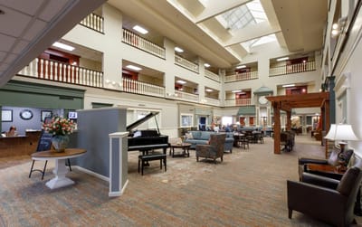Common area with seating, piano, and decor