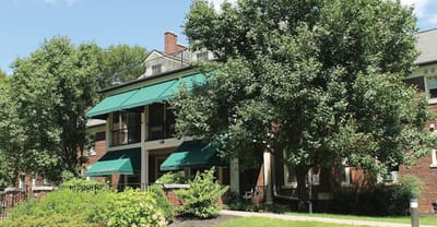 Front exterior view of a senior living facility with trees