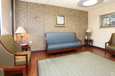 Seating area in a nursing home lobby with decorative walls