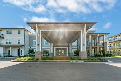 Building exterior view with entrance and landscaping