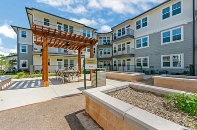 Community garden area with seating and building facade