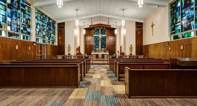 Interior view of a chapel with wooden pews