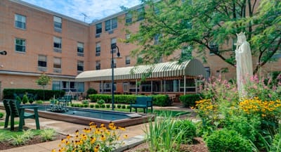 A landscaped outdoor courtyard with seating and flower beds