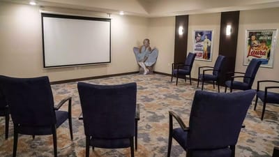 Interior of a common area with chairs and a screen
