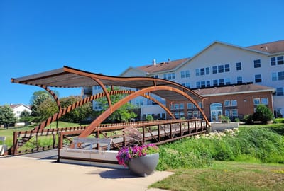 Beautiful outdoor bridge leading to a senior living facility