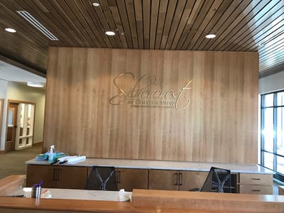Elegant logo on wooden wall in facility lobby