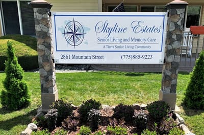 Sign for Skyline Estates Senior Living with landscaping