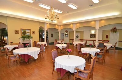 Bright dining room with tables and chairs set for meals