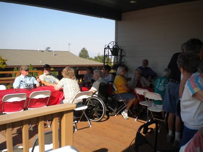 Seniors gathered on a patio for a community event