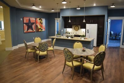 Interior view of a common area with dining tables and artwork