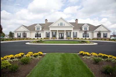 Exterior view of Spring Arbor facility surrounded by flowers