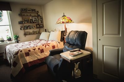 Cozy private room with a bed and armchair