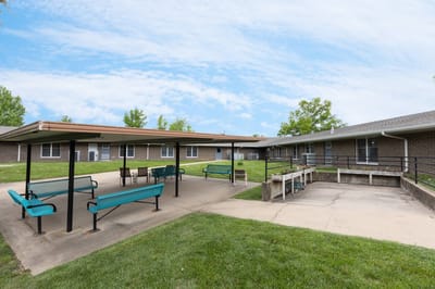 Outdoor seating area with shaded benches