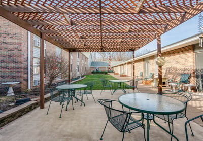 Outdoor patio area with seating and greenery
