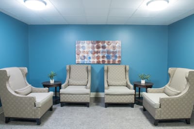 Cozy seating area with blue accent wall and artwork