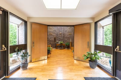 Entrance of Stonebridge Villa Marie with open doors and plants