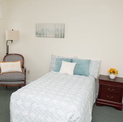 Cozy resident room with bed and chair