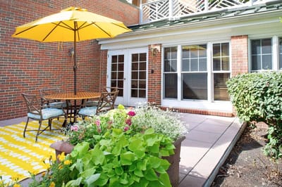 Outdoor patio area with seating and flowers