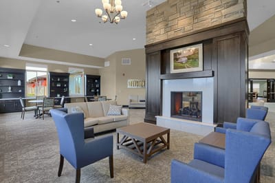 Bright lounge area with comfortable seating and a fireplace