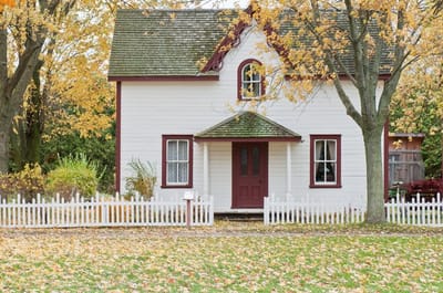 Exterior view of a charming house surrounded by autumn foliage
