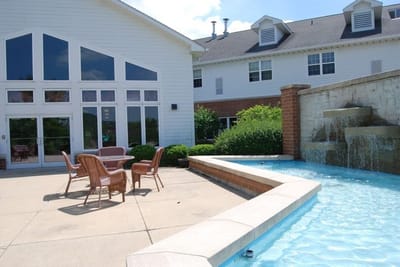 Outdoor space with seating and a water feature