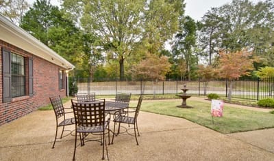 Outdoor seating area with a fountain and garden