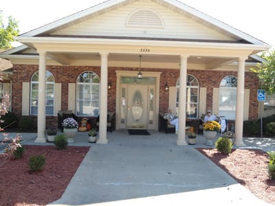 Entrance of a senior living facility with seating and decor