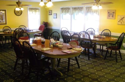 Cozy dining area with wooden tables and chairs