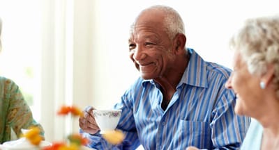 Senior man enjoying tea with friends