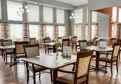 Bright dining room with tables set for meals