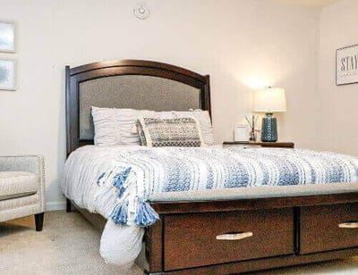 Cozy bedroom with a neatly made bed and soft lighting