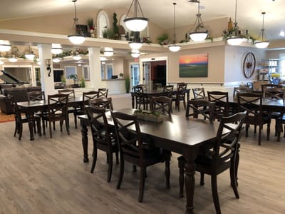 Dining area with wooden tables and chairs in a bright room