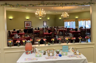 Dining room decorated for a celebration with food and flowers