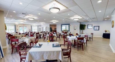 Dining room with neatly set tables and chairs