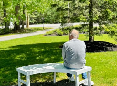 Resident enjoying a peaceful moment in the garden