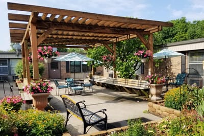 Outdoor seating area with flowers and umbrellas