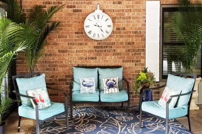 Outdoor seating area with a clock and plants