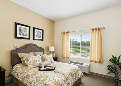 Cozy furnished resident room with floral decor