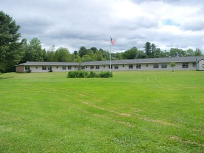 Exterior view of The Meadows facility with grassy area