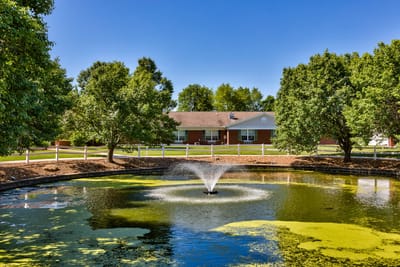 Exterior view of a pond and building at the facility