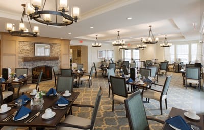 Bright dining room with neatly set tables and chairs